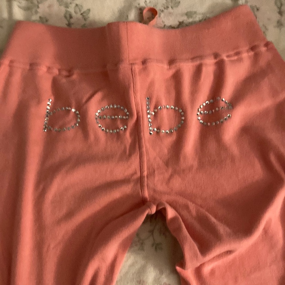 Bebe LG. Light weight coral colored adorable BeBe rhinestones on the butt.